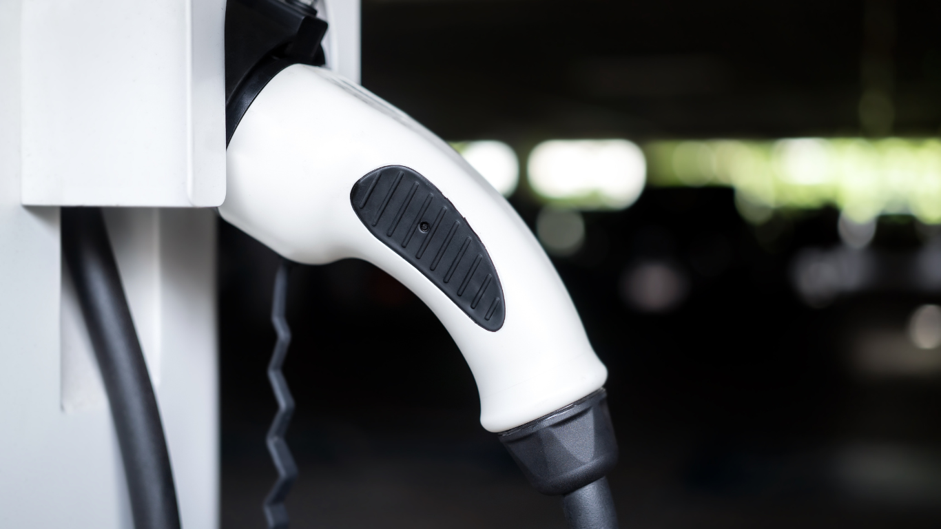 Ładowarka mobilna EV na tle samochodu elektrycznego od Feyree